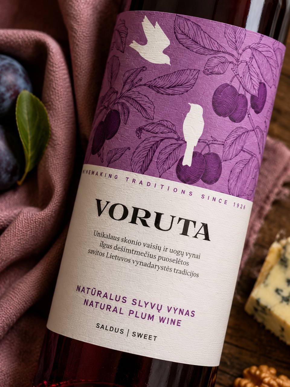 Voruta Natural Plum Wine purple botanical label detail with plums and cheese