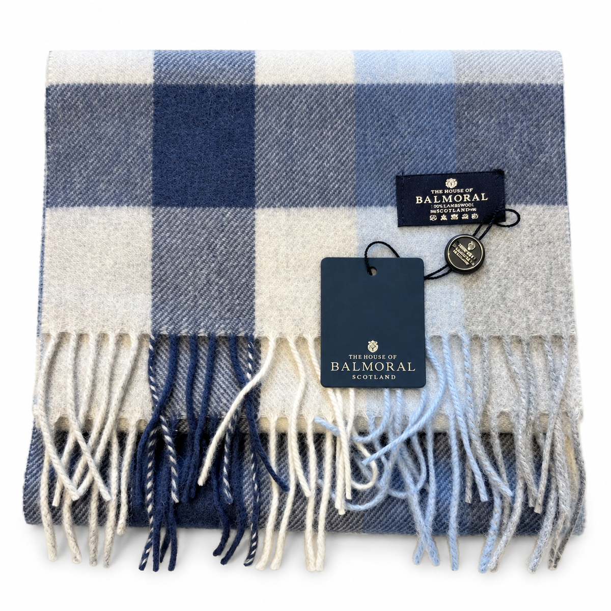     Folded Balmoral lambswool scarf featuring an oversized blue, beige and grey check pattern with tags