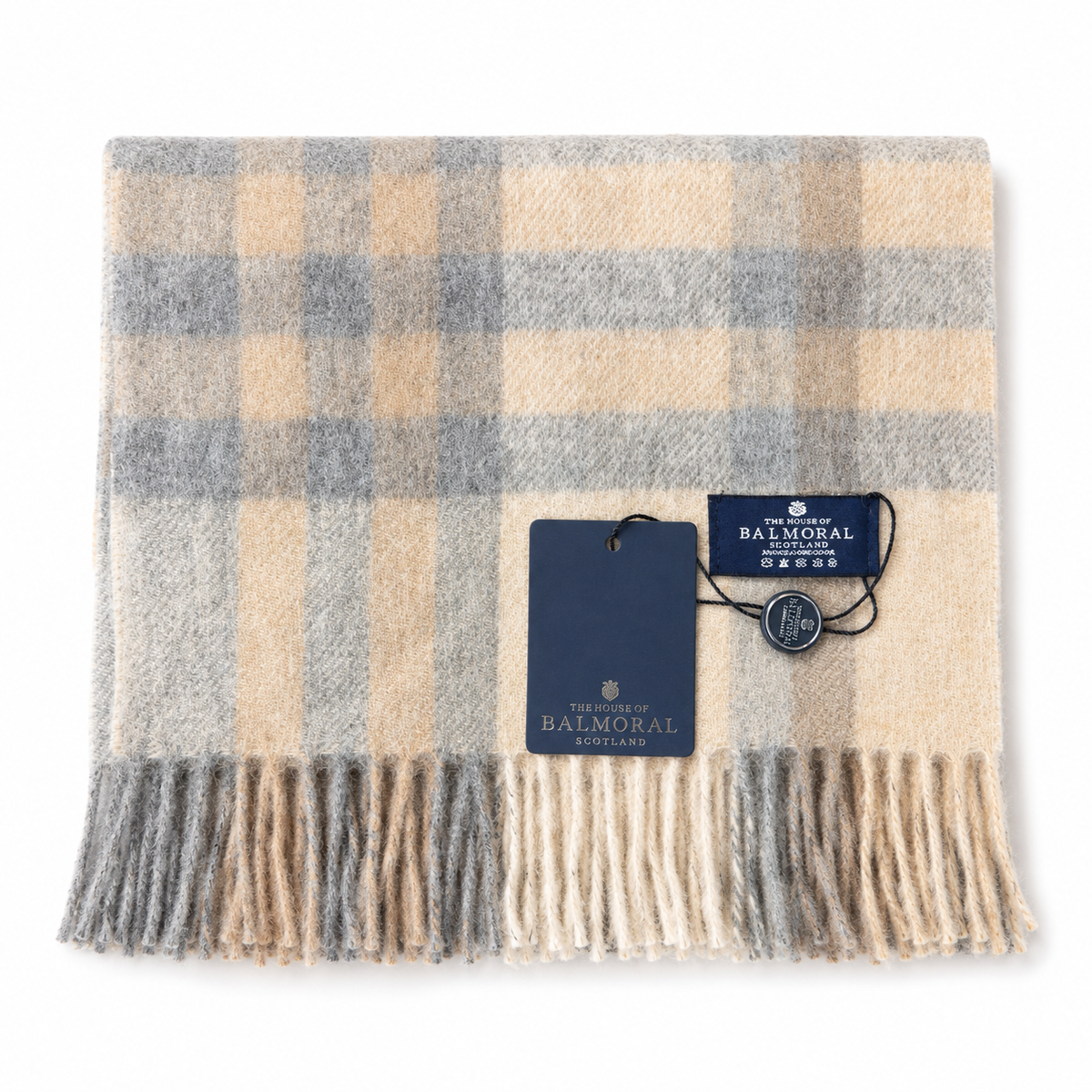 Folded House of Balmoral 100% lambswool scarf with a natural cream, beige and grey check pattern