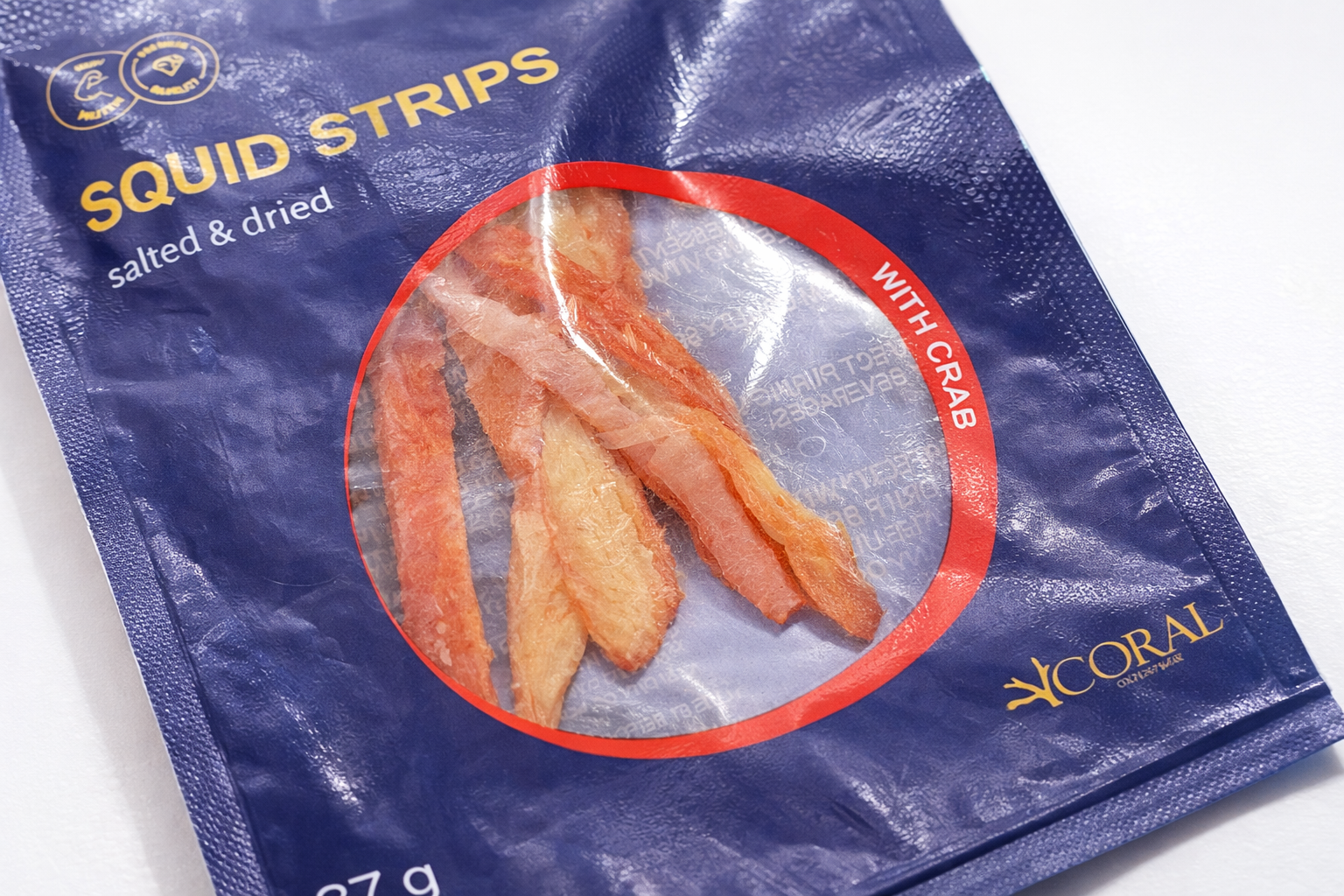 Close up of salted dried squid strips with crab flavour showing texture detail