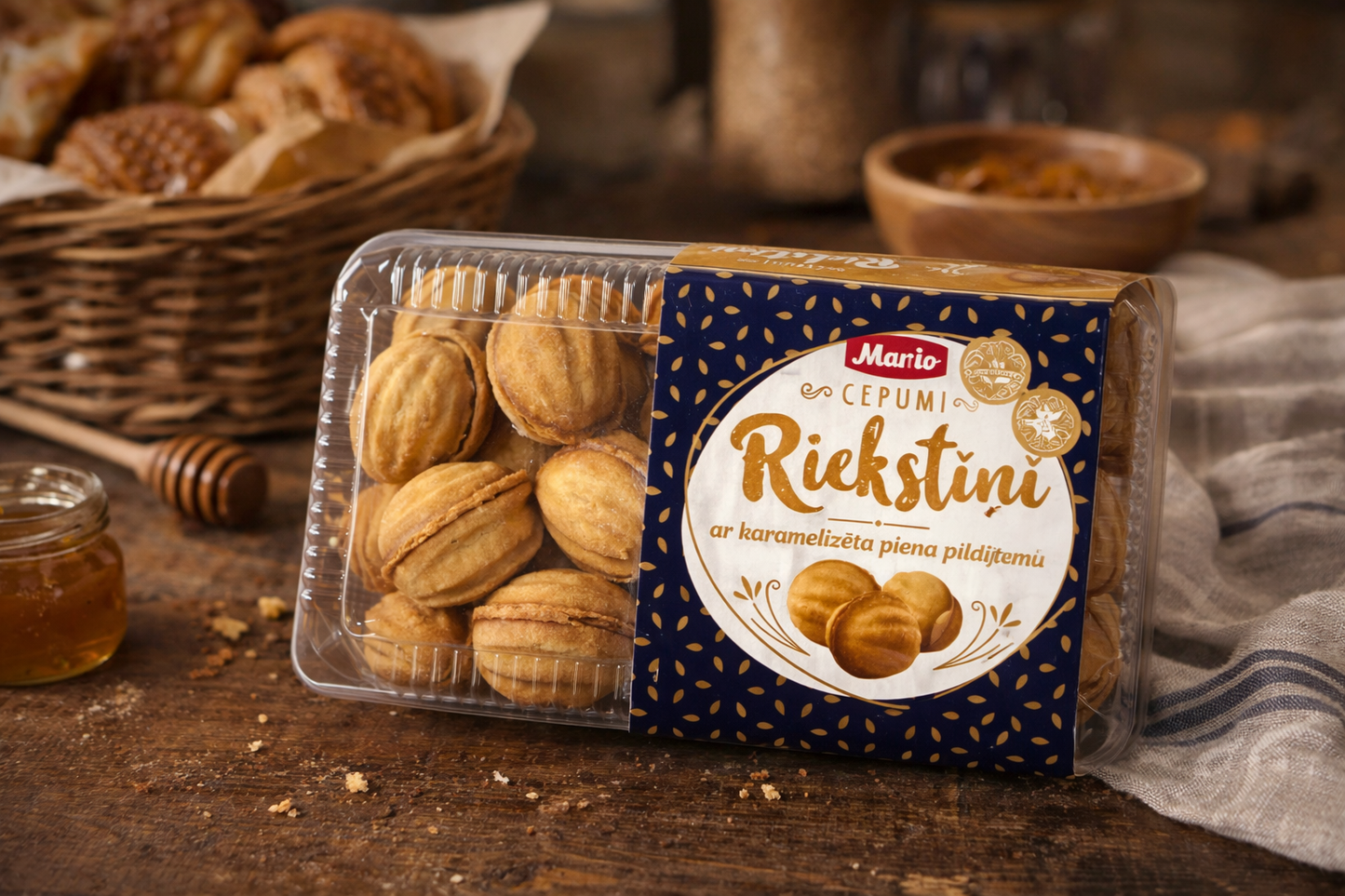 Mario Riekstiņi walnut shaped cookies with caramelised milk filling in plastic box on rustic wooden table with honey and tea setting